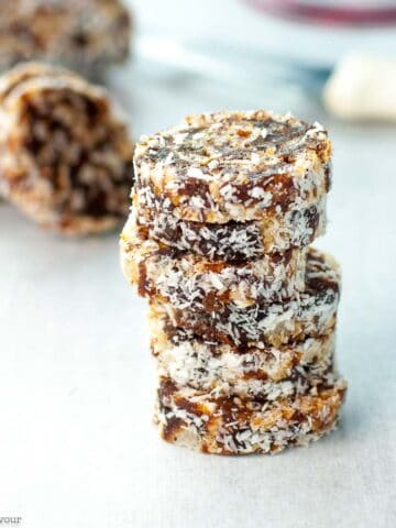 No bake coconut date logs sliced and stacked.