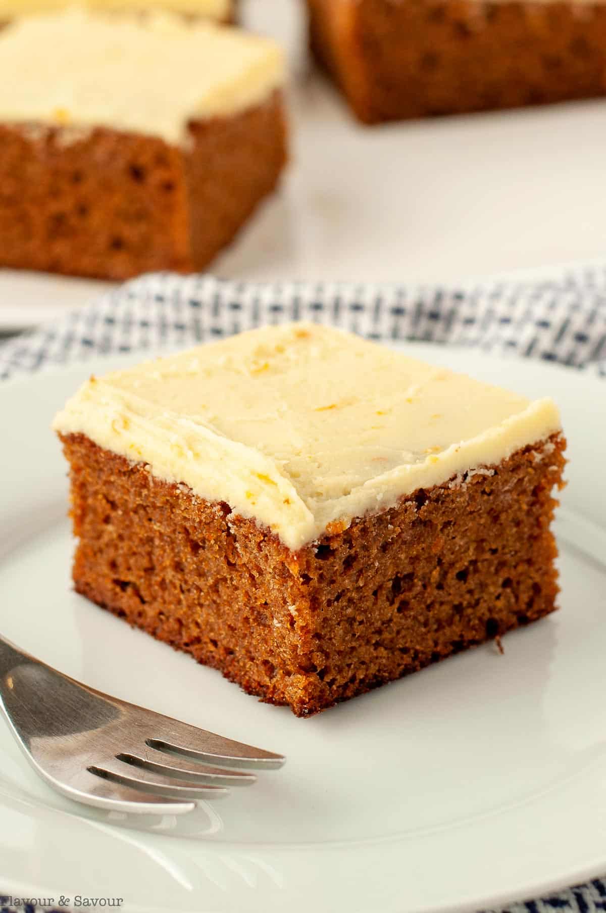orange gingerbread cake on a plate with a fork