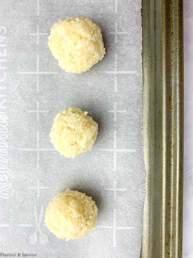 coconut balls on a baking sheet