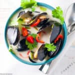 A bowl of steamed Thai mussels in coconut milk