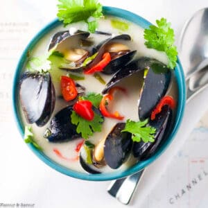 A bowl of steamed Thai mussels in coconut milk