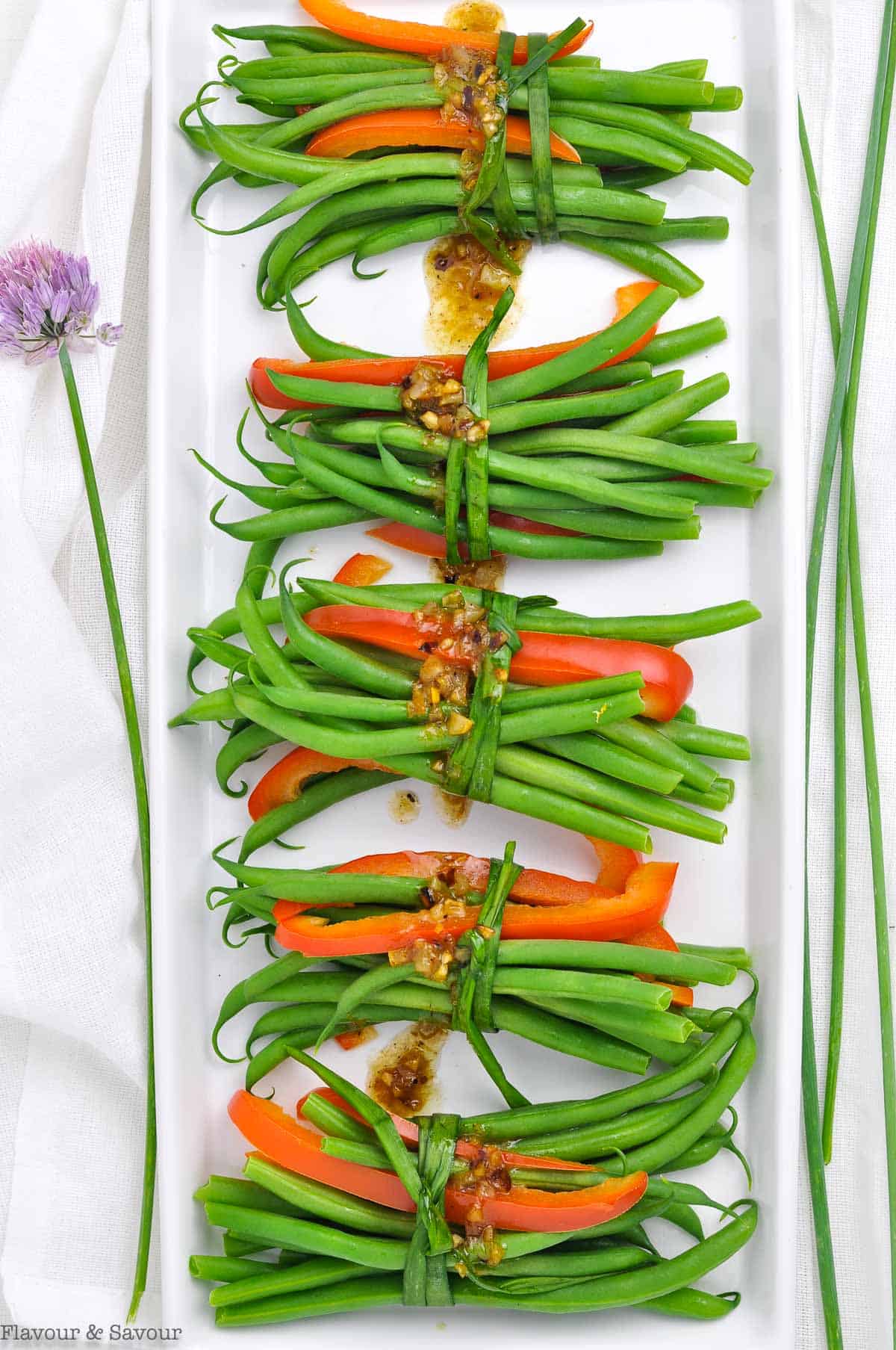 green bean bundles with red pepper strips.