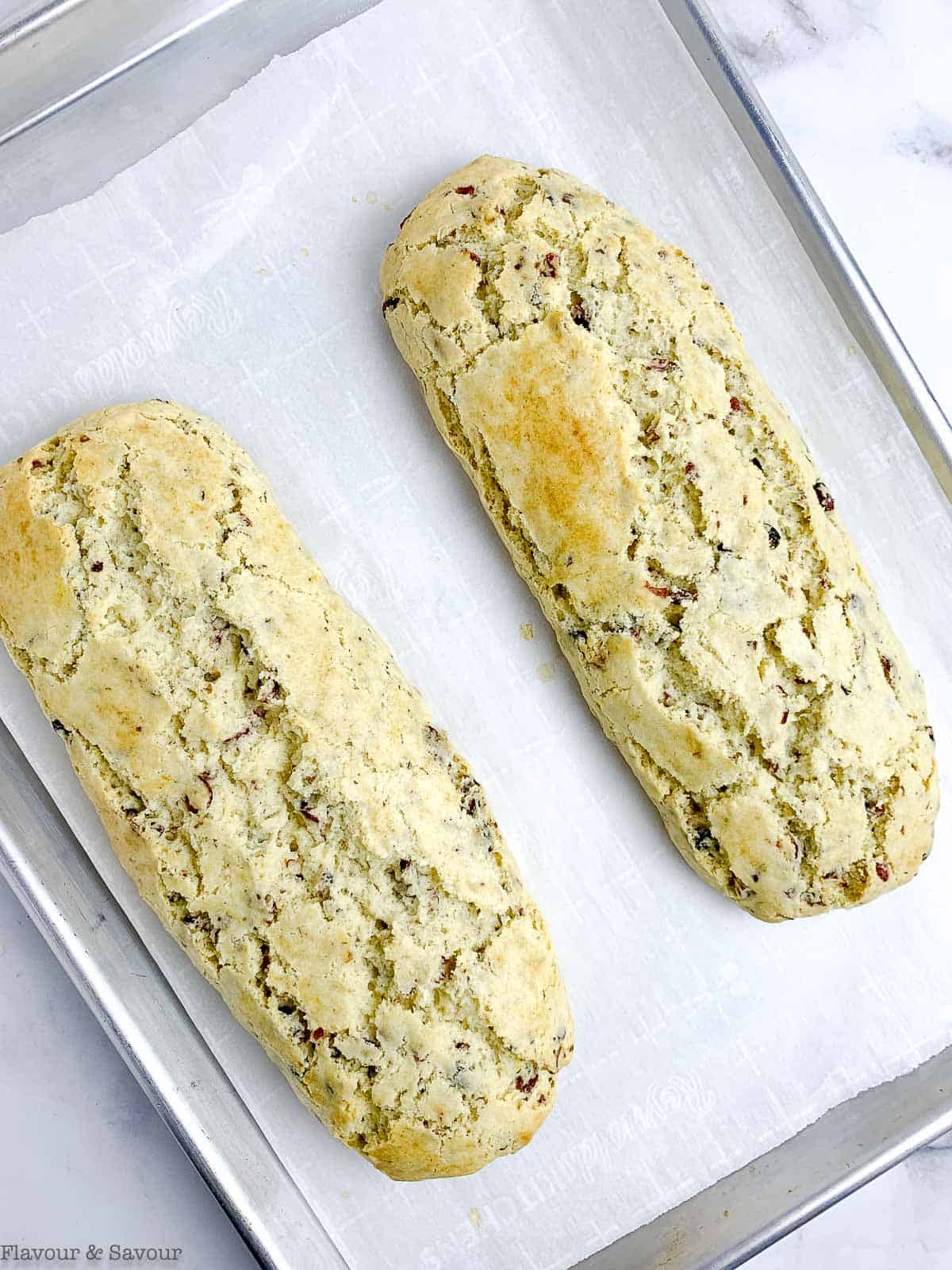 baked biscotti logs on a baking sheet