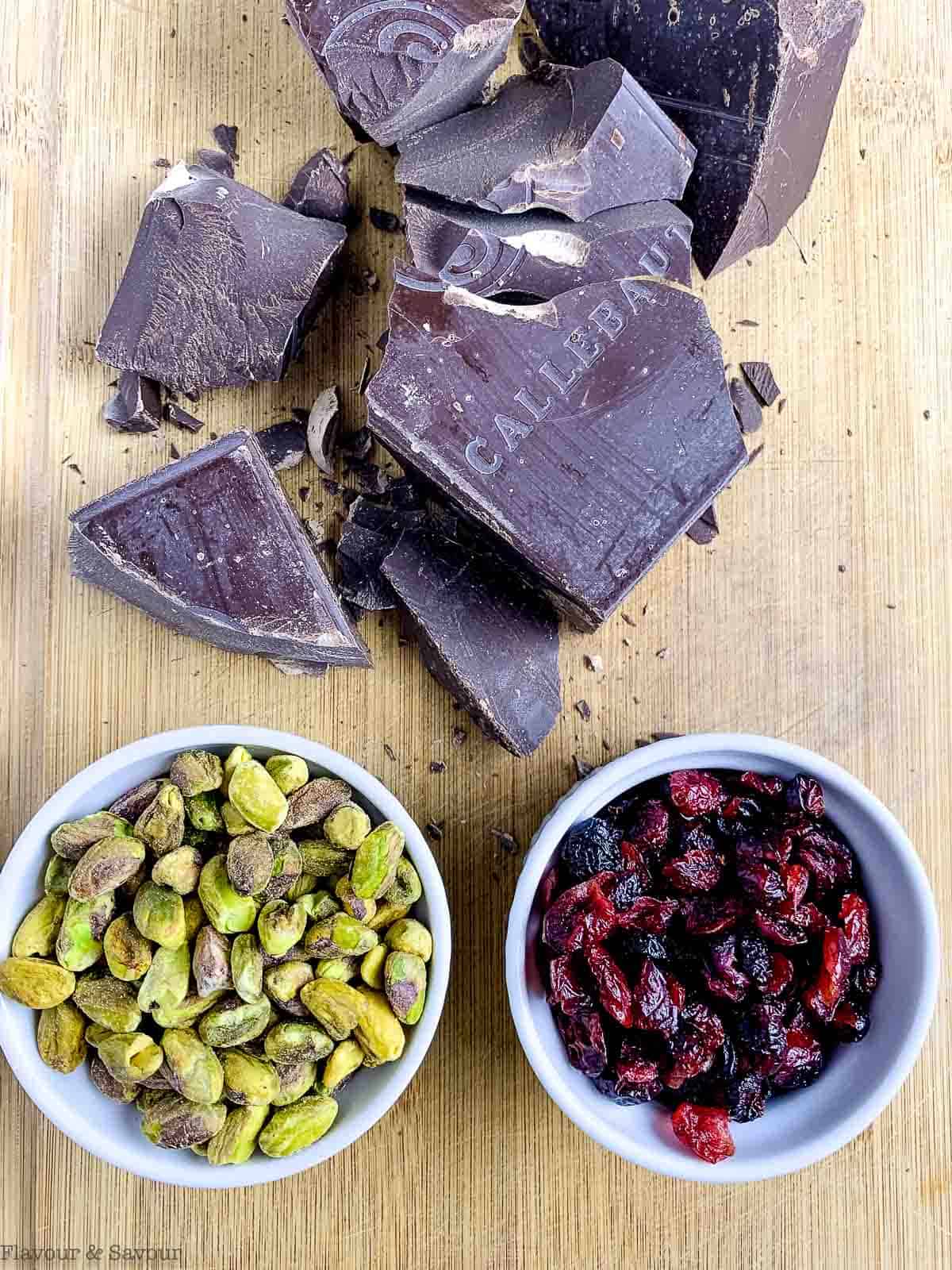 ingredients for cranberry pistachio chocolate bark: baking chocolate, dried cranberries and shelled pistachios.