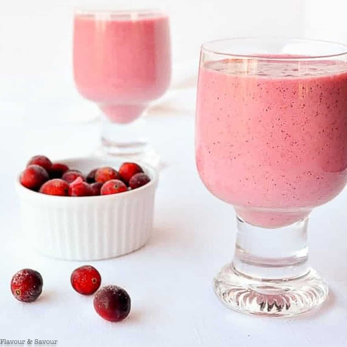 two glasses filled with cranberry raspberry smoothie