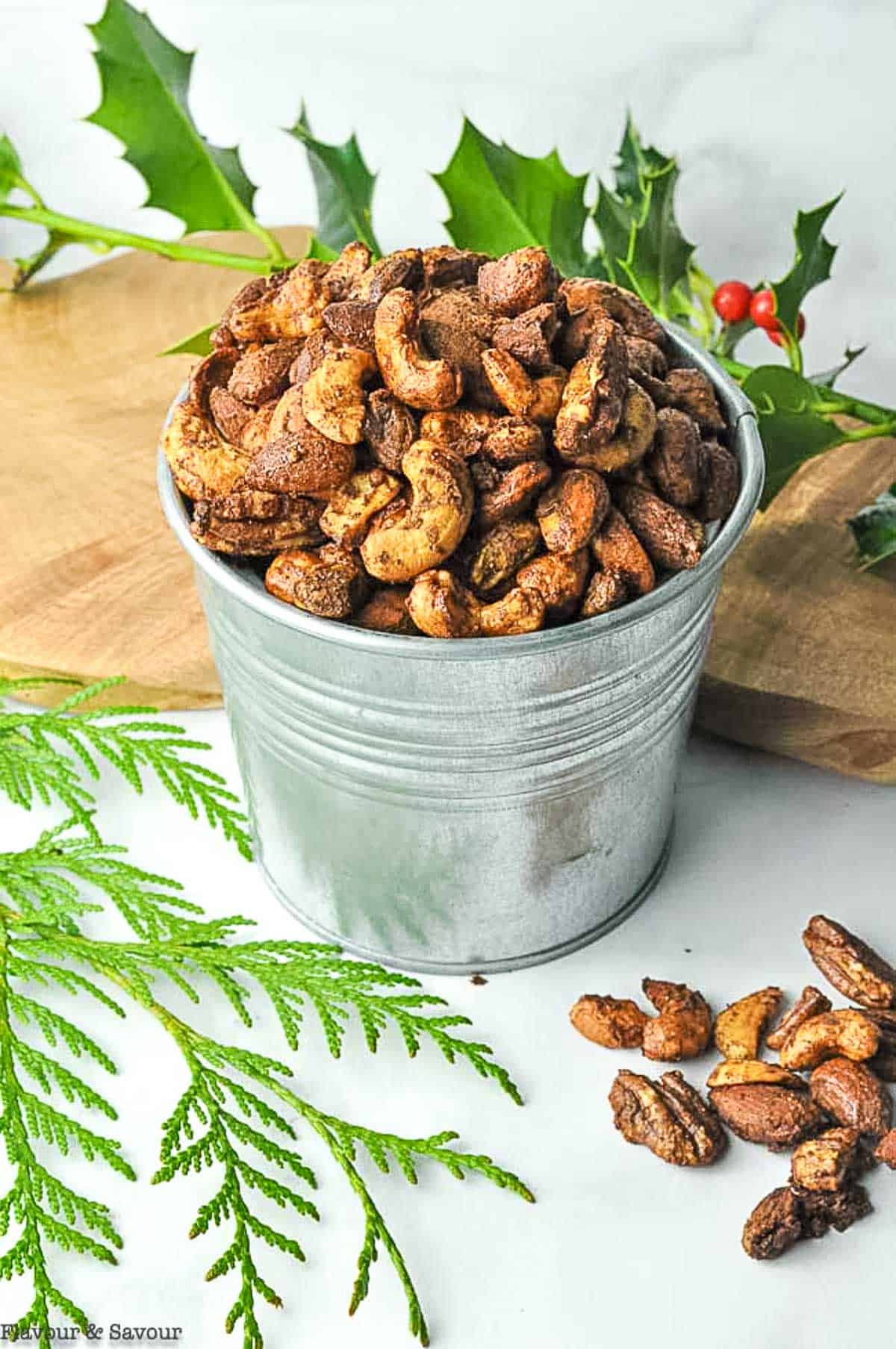 gingerbread spiced nuts in a tin with holly branches