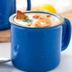 a blue mug filled with seafood chowder