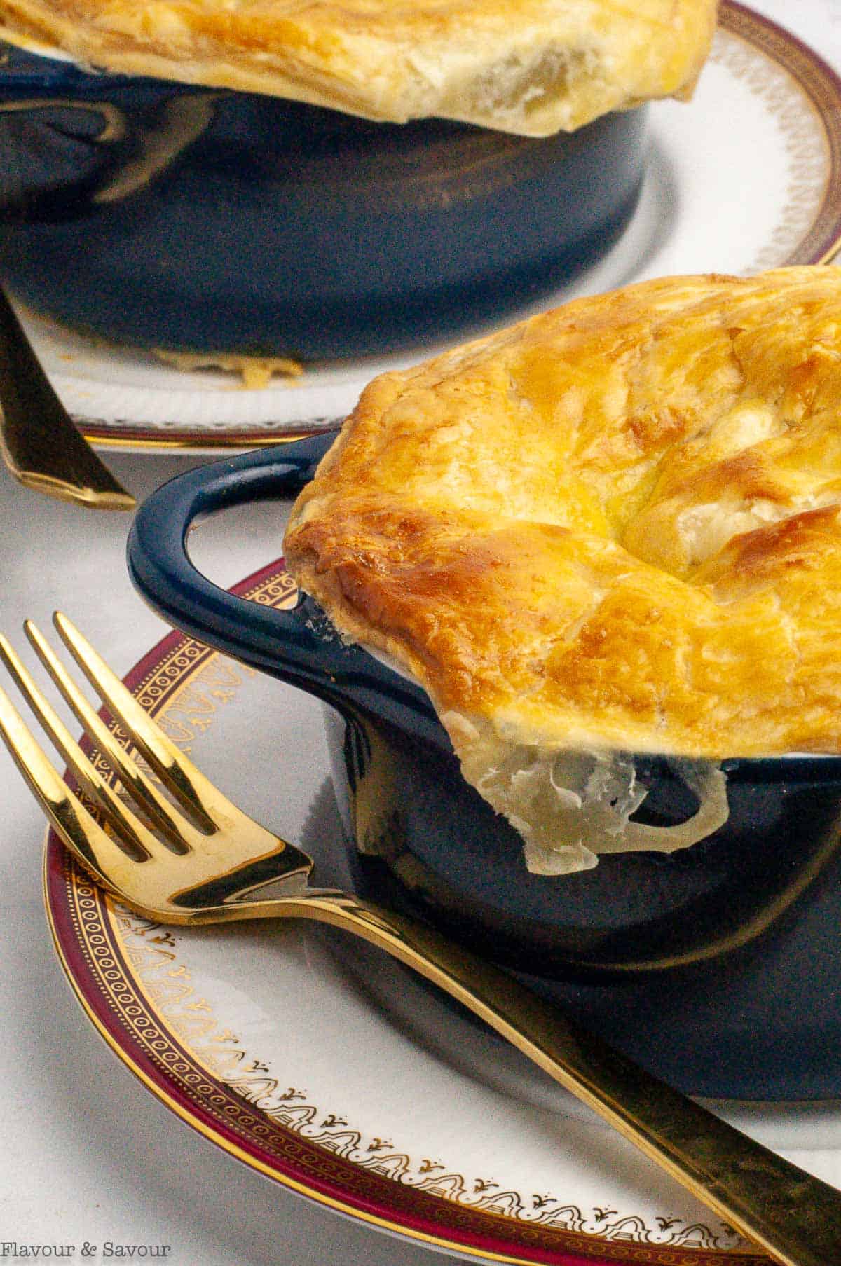 2 cocottes of seafood pot pie topped with puff pastry