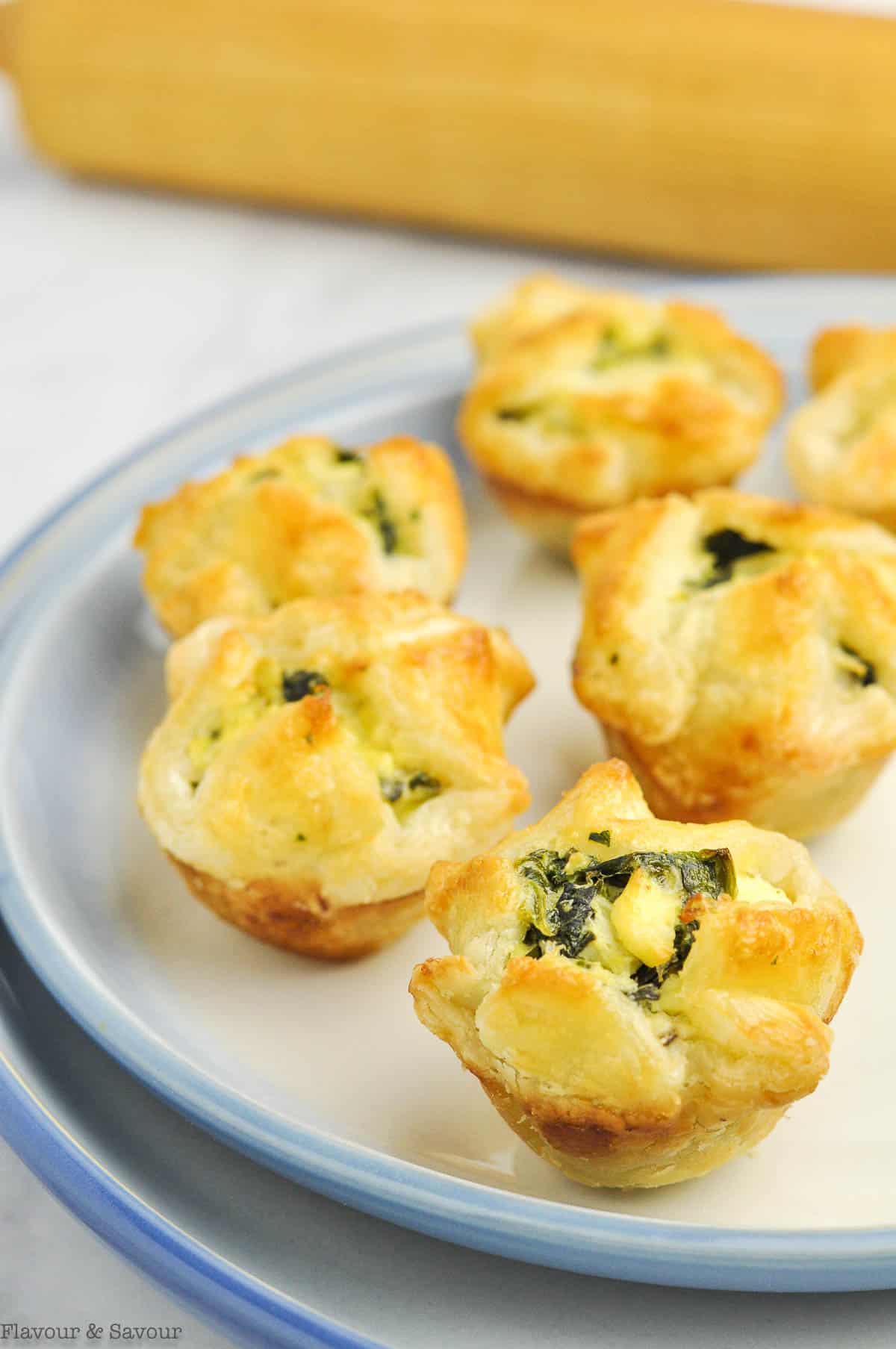 Buttery puff pastry filled with spinach, artichokes and cheese in tiny puff pastry cups