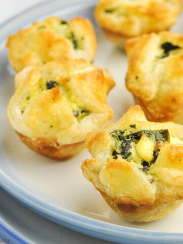 spinach artichoke puff pastry cups on a plate