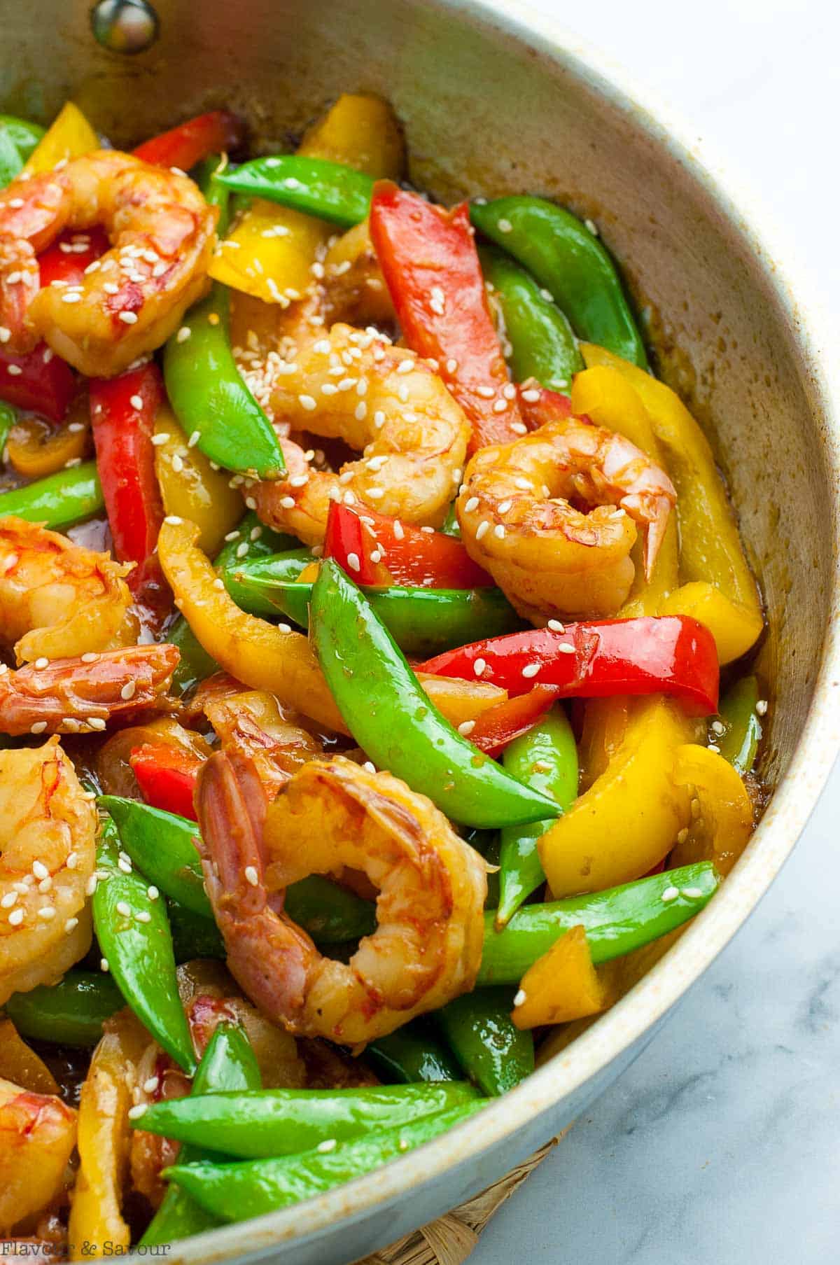 Lemon Garlic Shrimp stir fry with sugar snap peas and peppers in a skillet