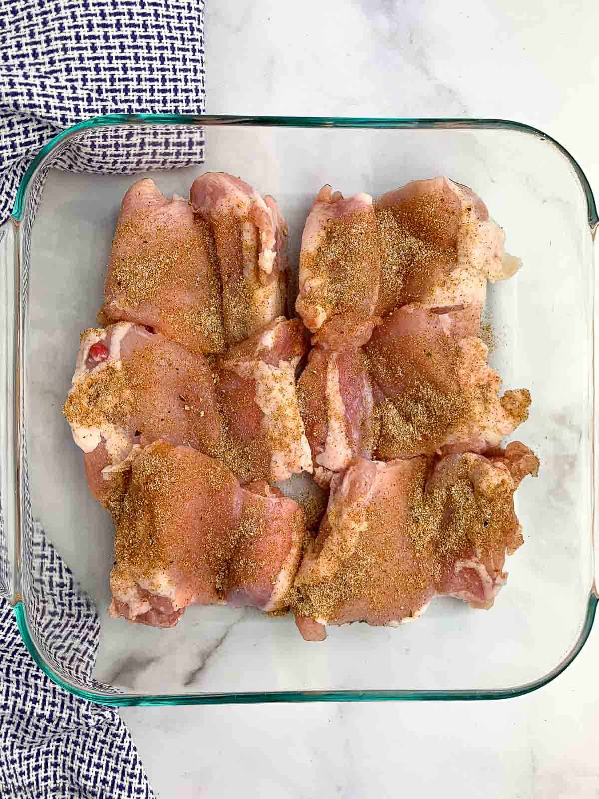 Chicken thighs sprinkled with spices.