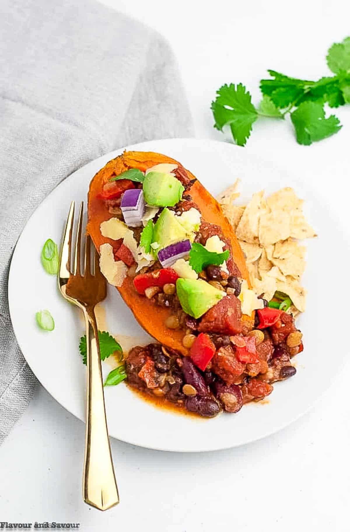 Vegan chipotle chili on a baked sweet potato