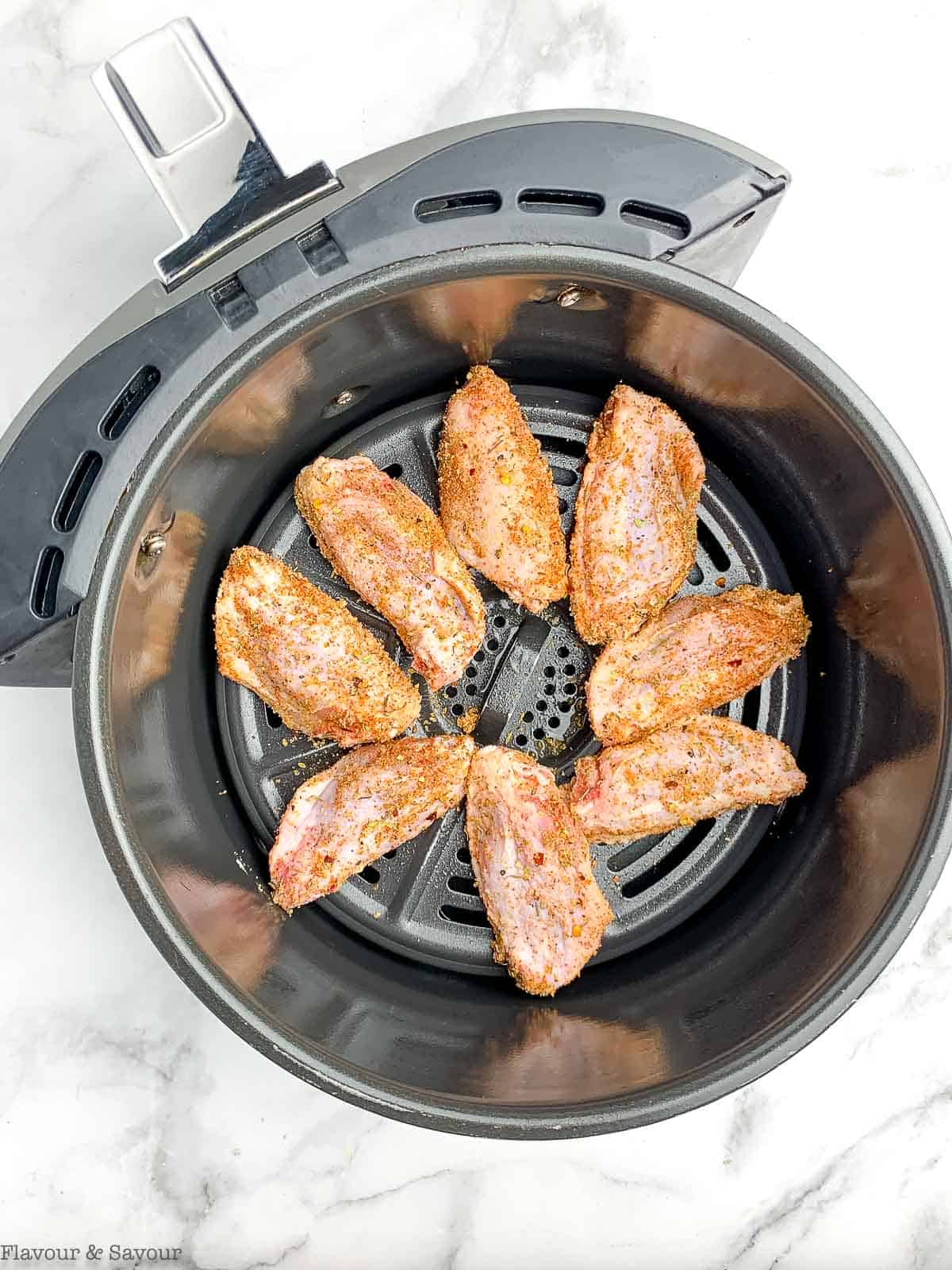 chicken wings in a Ninja air fryer basket.