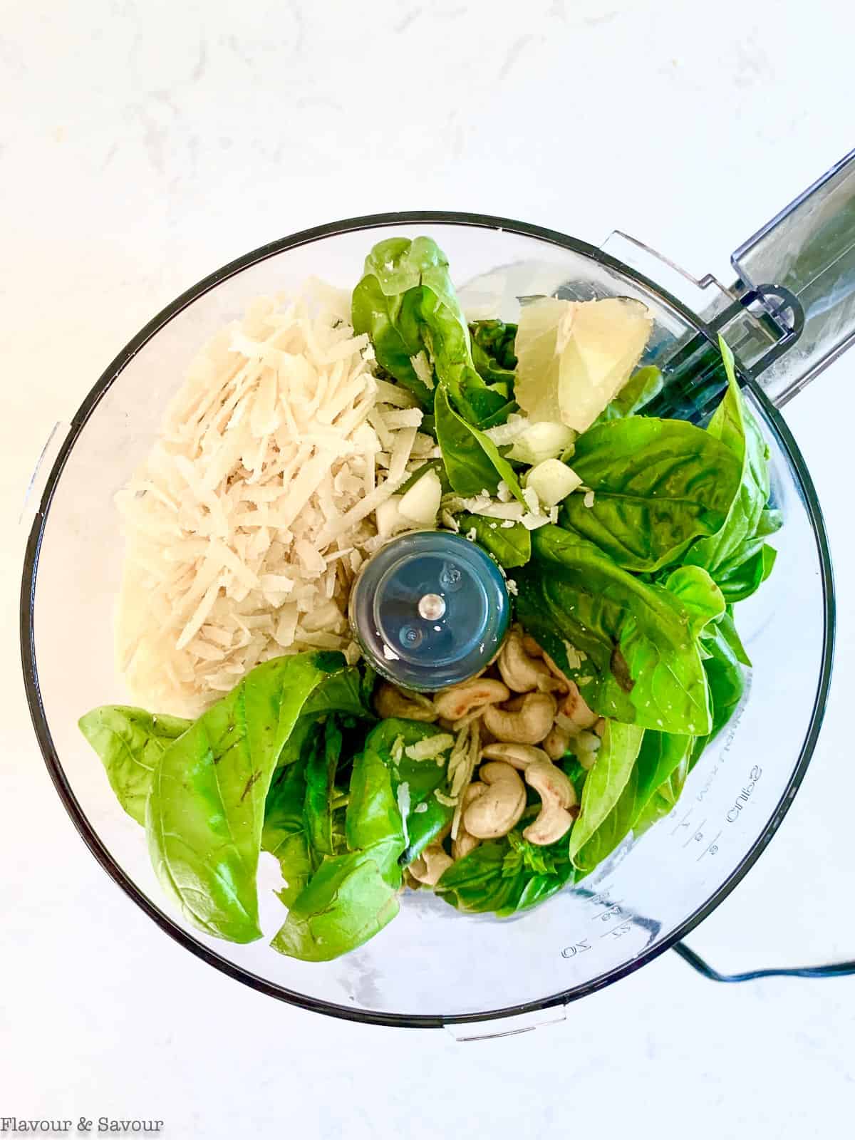 Pesto ingredients in a food processor.