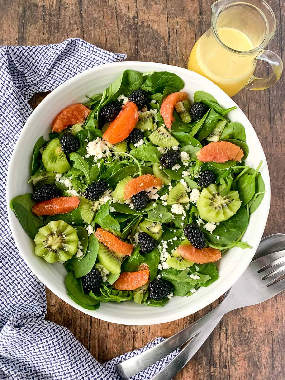 overhead view of a blackberry kiwi salad with oranges