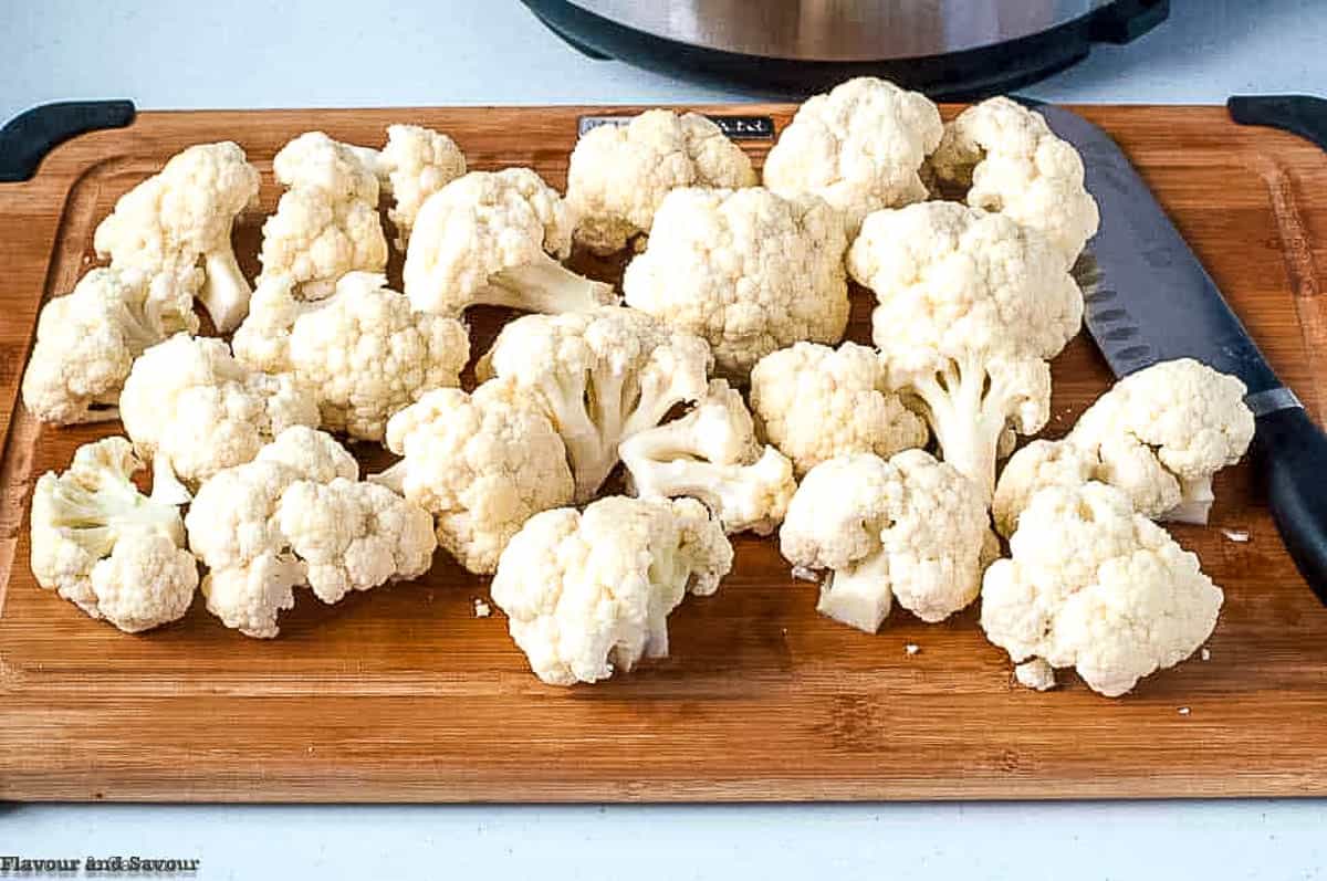 cauliflower florets on a cutting board.