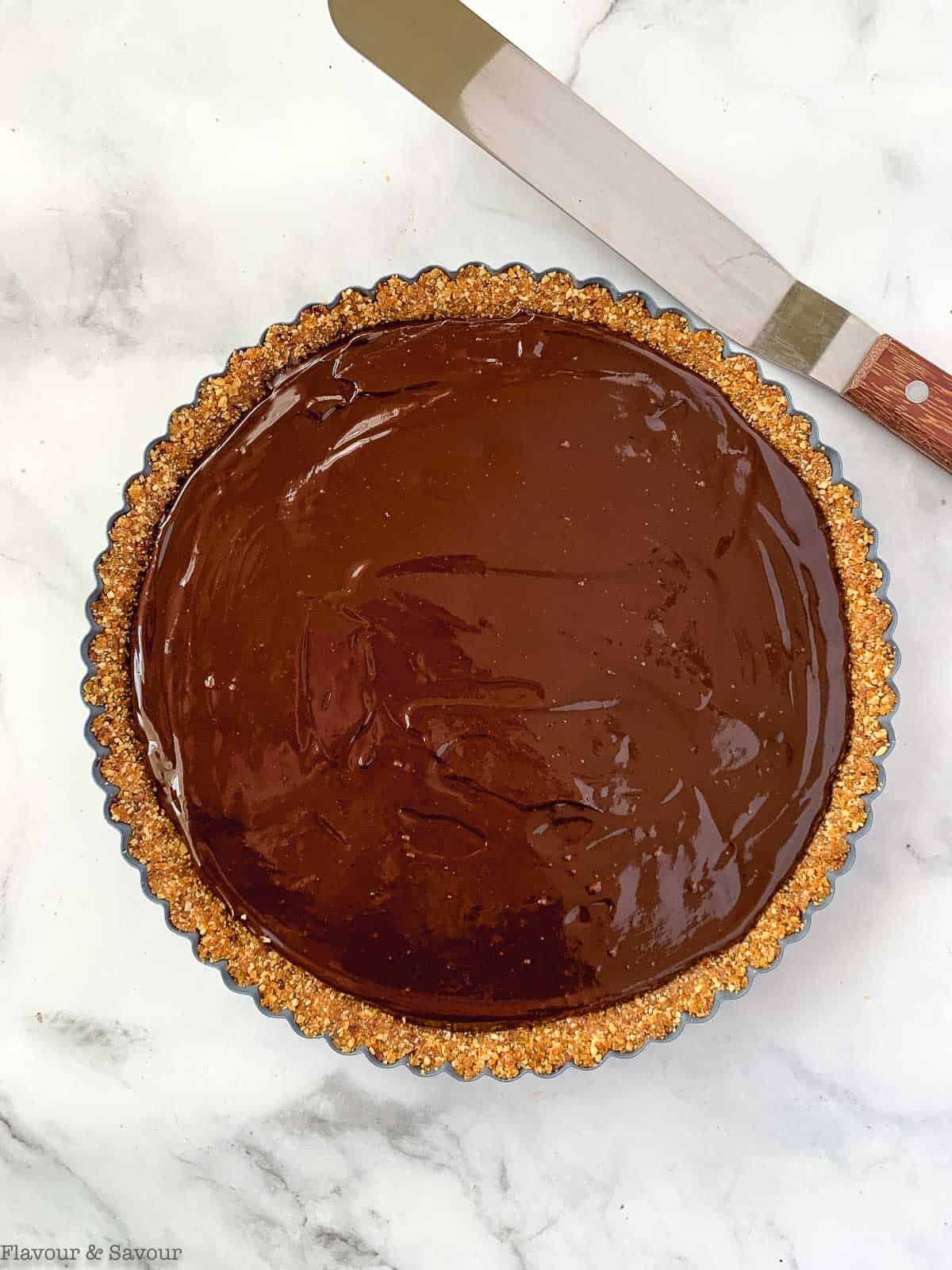 chocolate filling spread into a hazelnut crust.