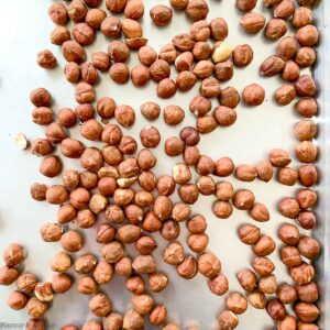 raw hazelnuts on a baking sheet