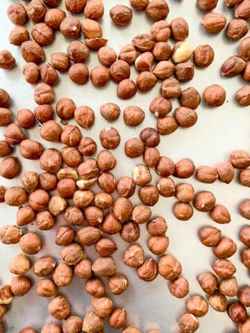 raw hazelnuts on a baking sheet