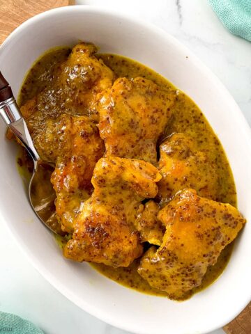 a bowl of honey-mustard chicken thighs