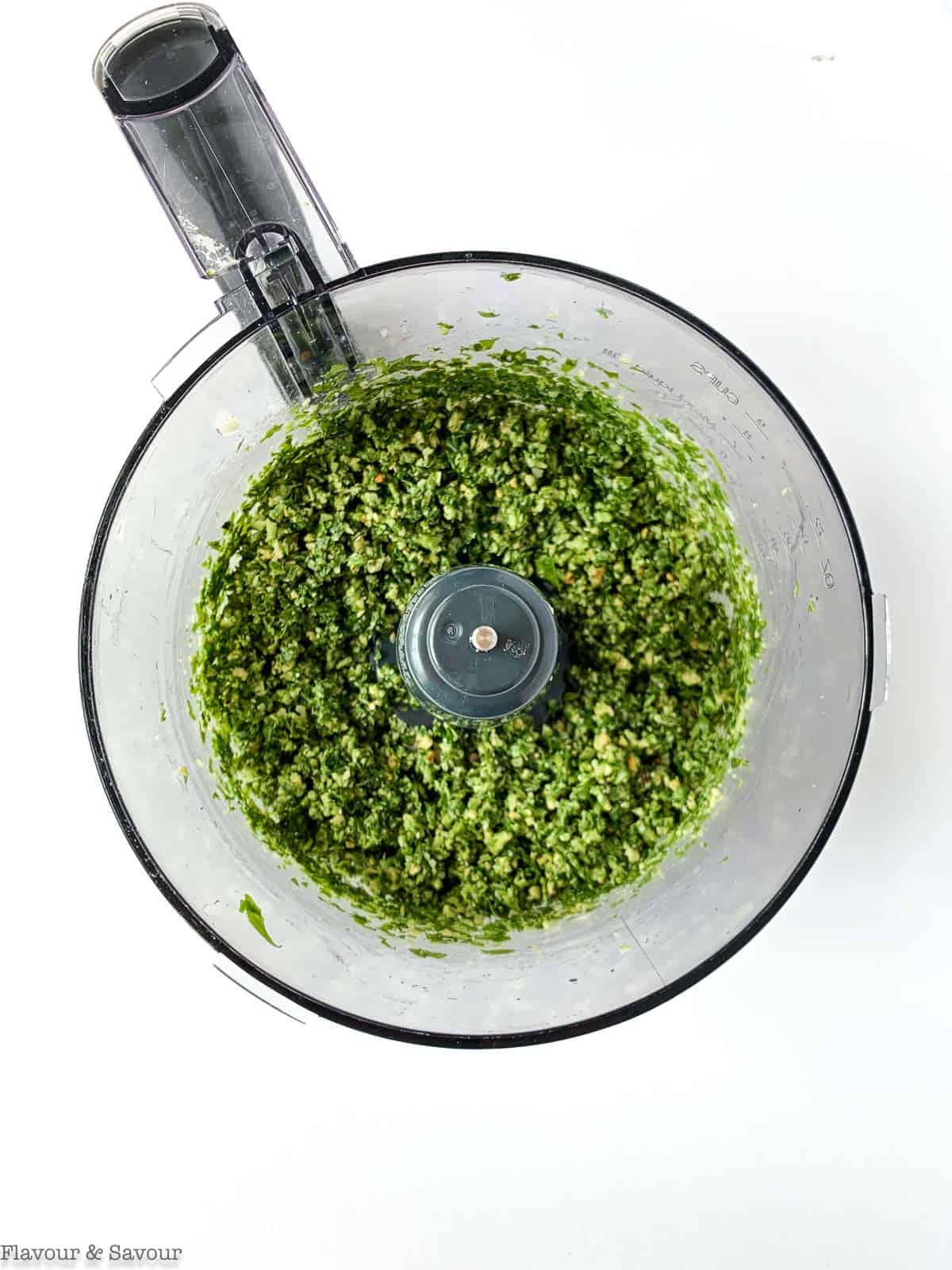 Basil pesto in a food processor bowl.