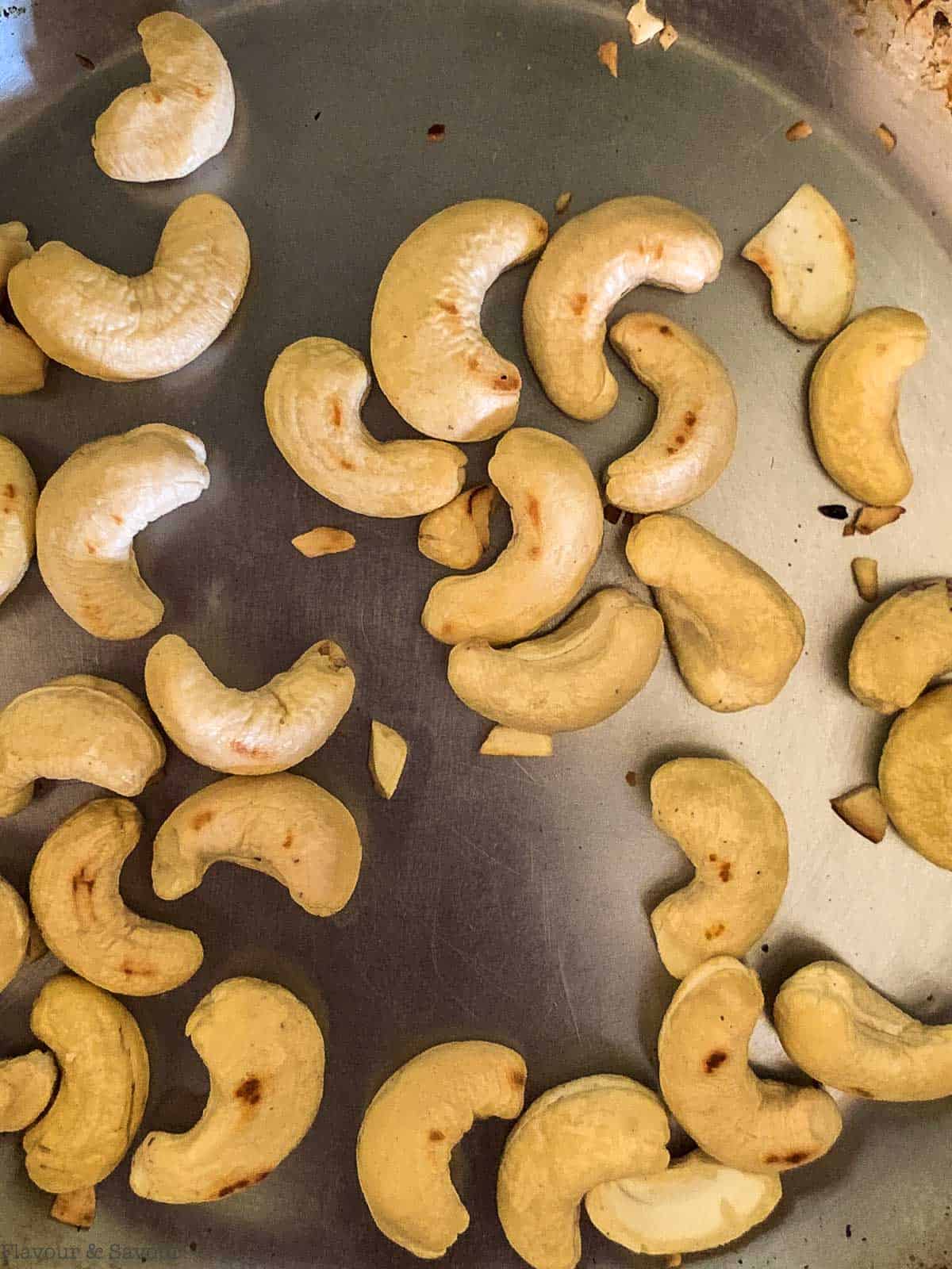Toasted cashews in a skillet.