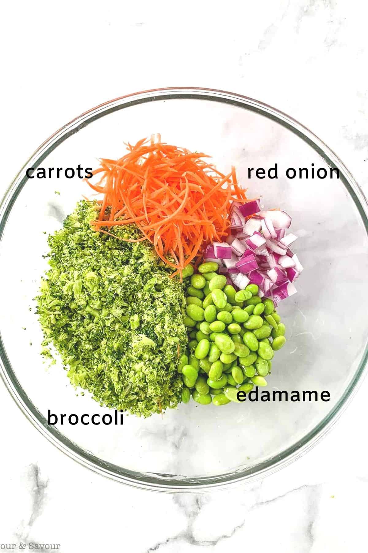 broccoli salad ingredients in a glass bowl
