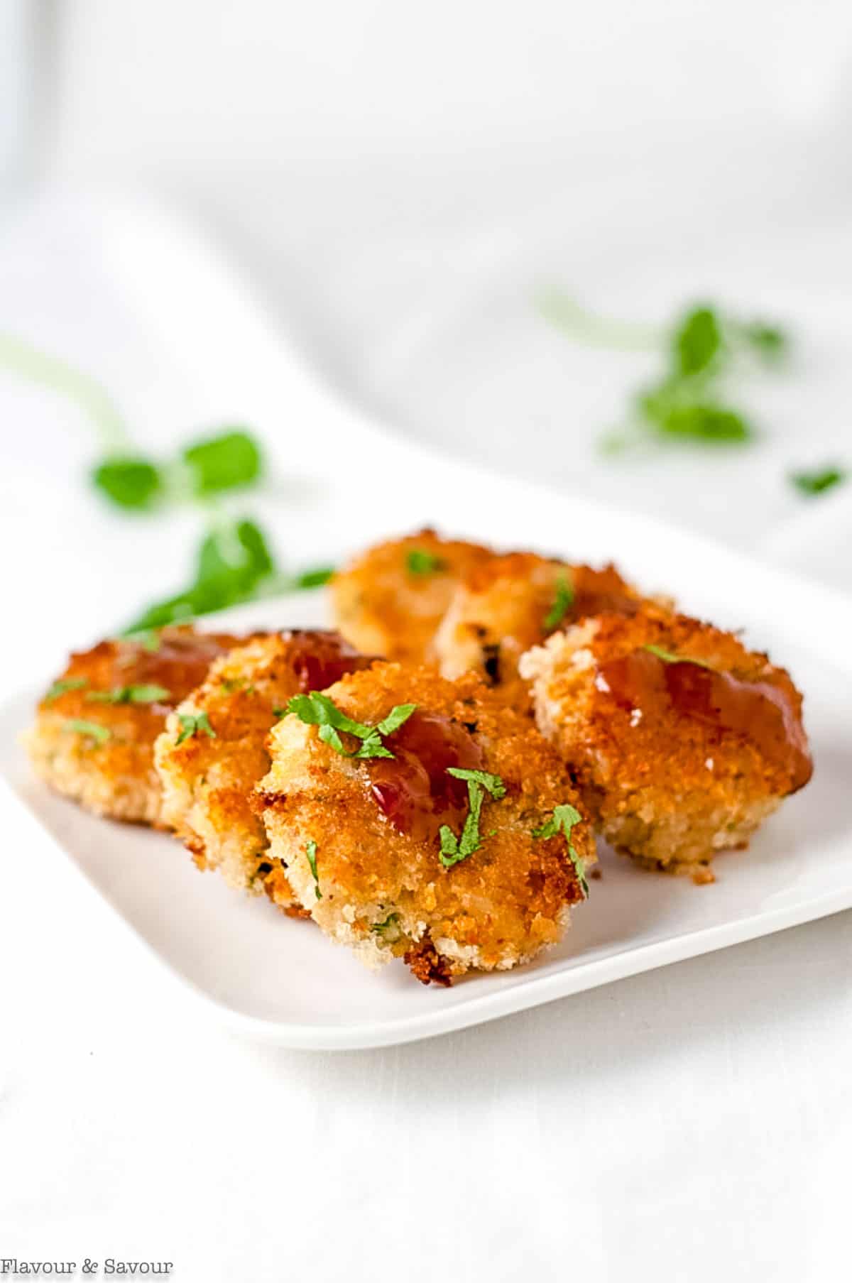 6 Thai-style crab cakes on a small white plate.