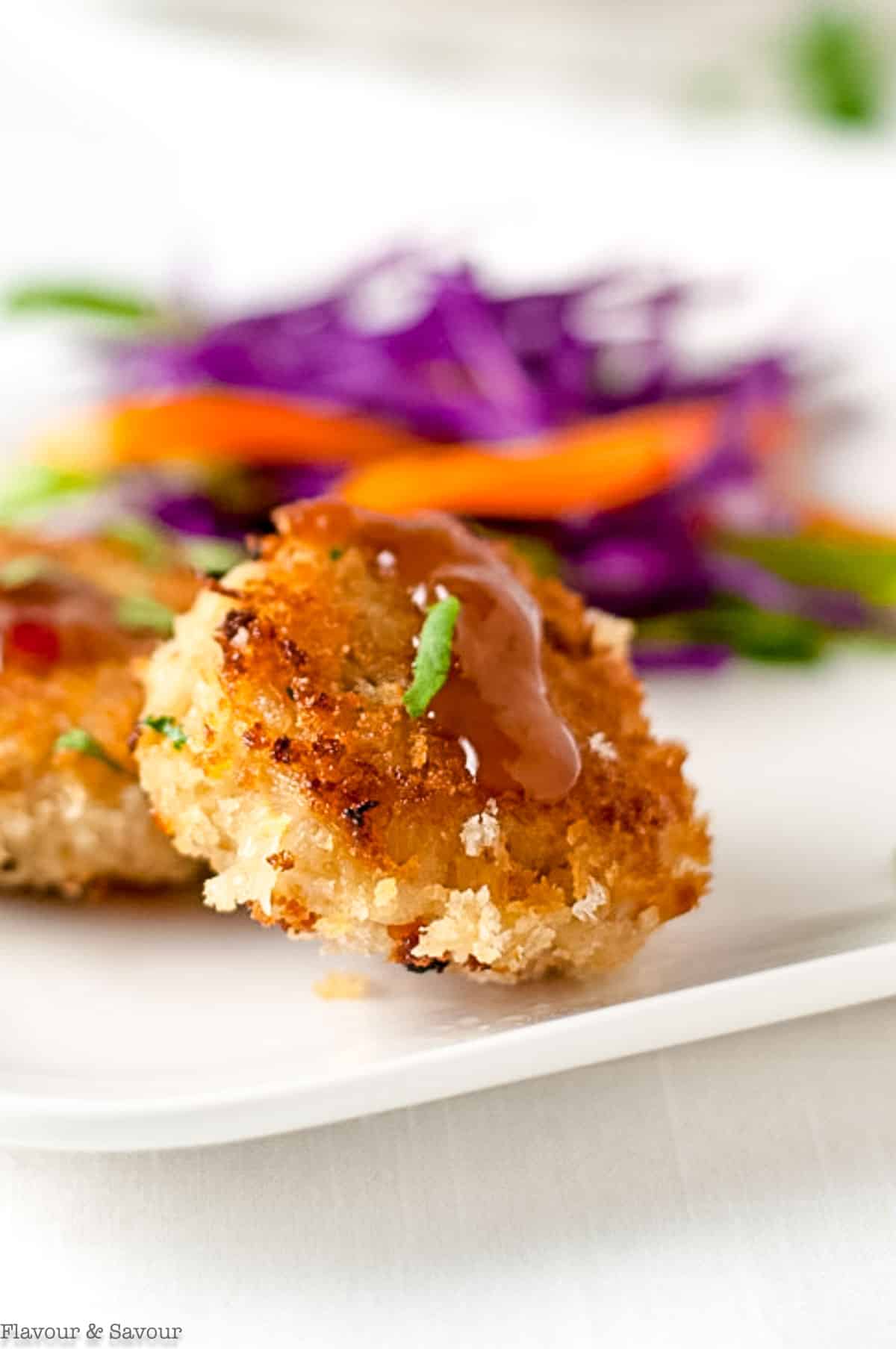 Close up view of Thai crab cakes with spicy dip.