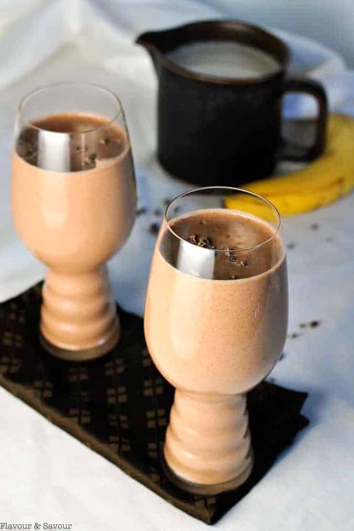 Two glasses of vegan chocolate almond smoothie with hemp hearts.