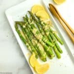 asparagus spears with lemon tahini dressing and hemp hearts
