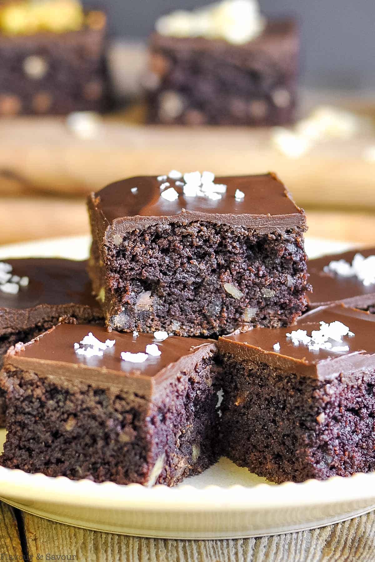close up views of brownies with paleo chocolate ganache frosting