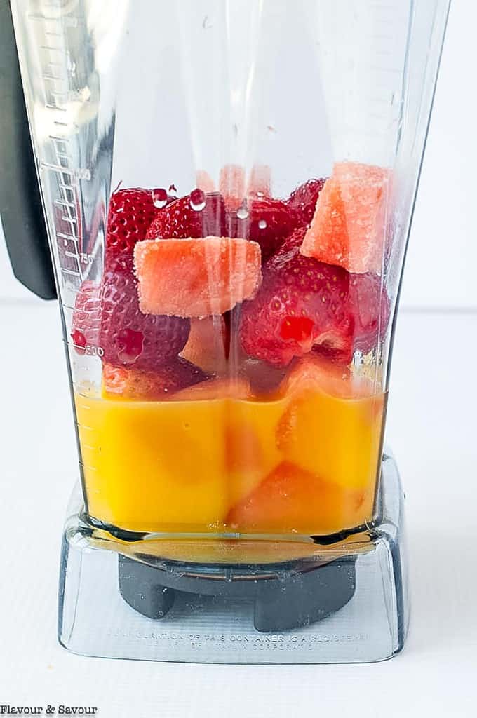 ingredients for strawberry watermelon collagen smoothie in a blender