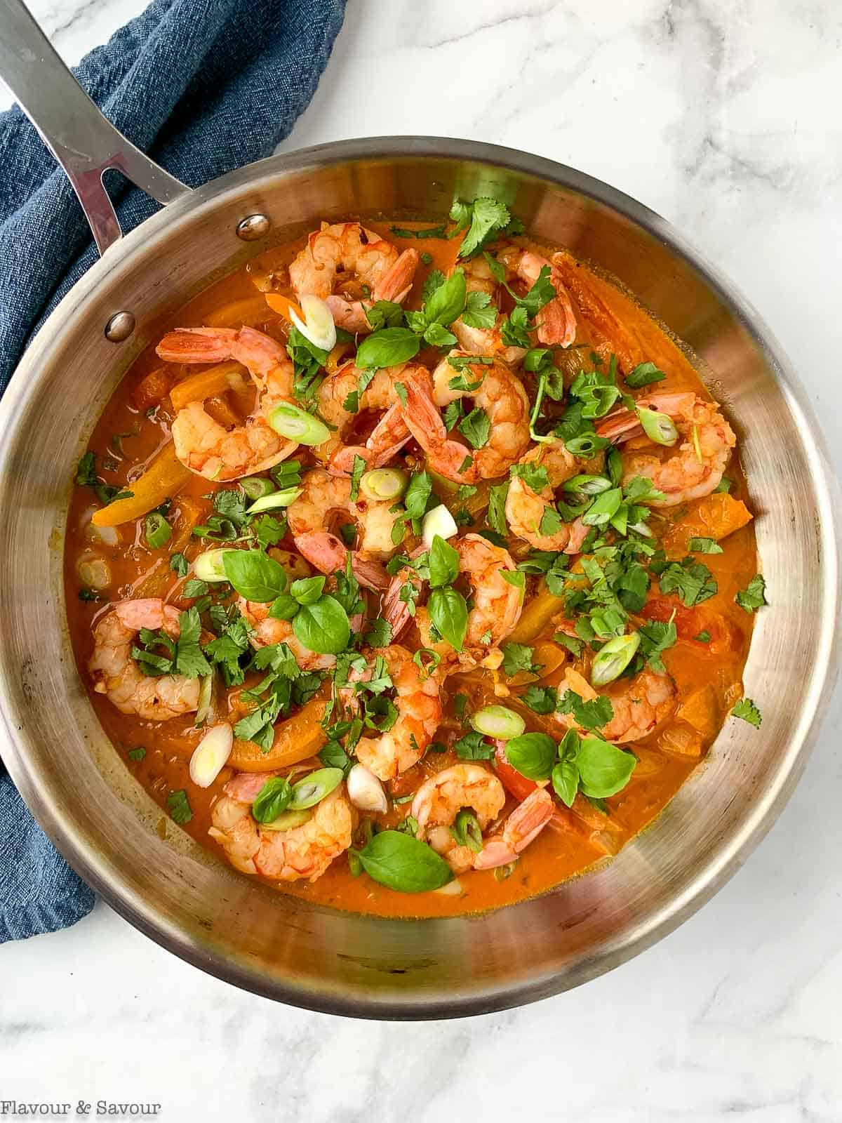 thai red curry with shrimp in a skillet
