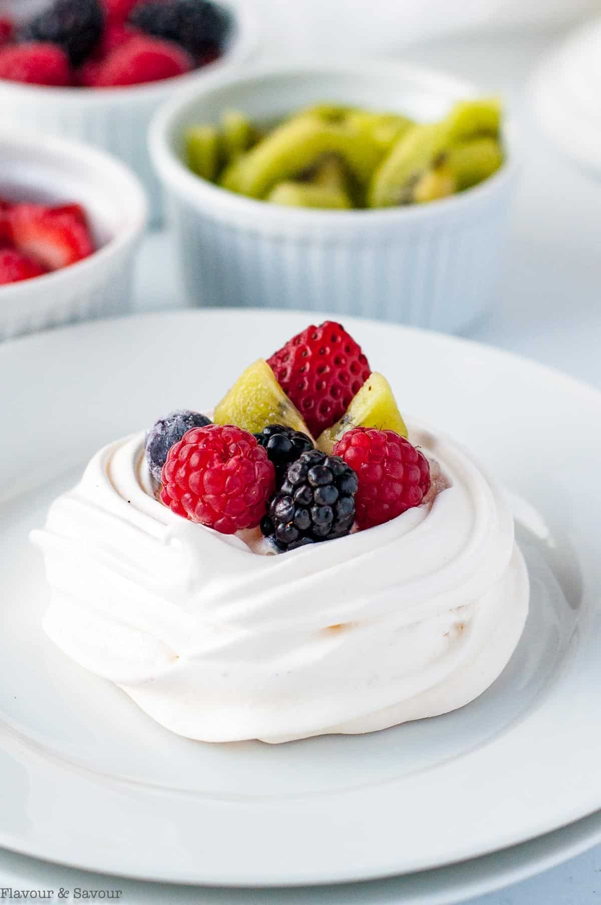 mini pavlova with fresh berries and kiwi fruit.