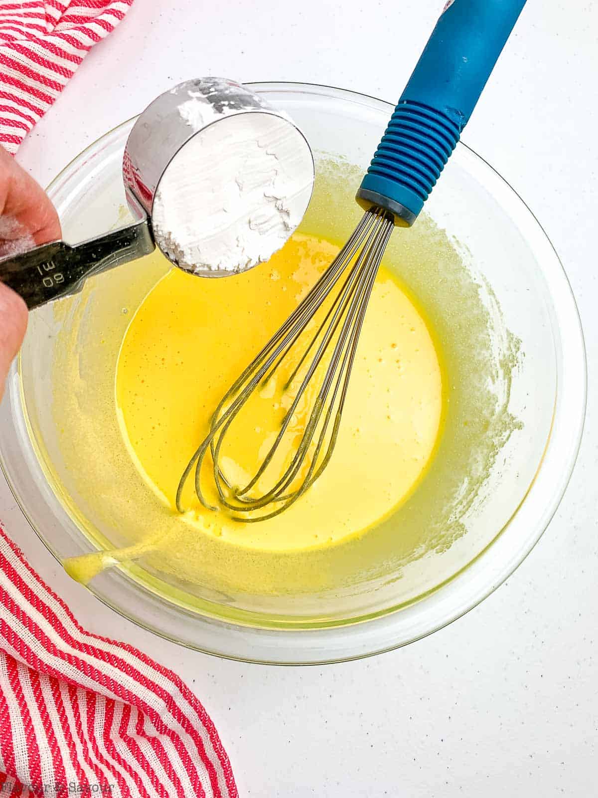 adding cornstarch to egg yolks for vanilla pastry cream.