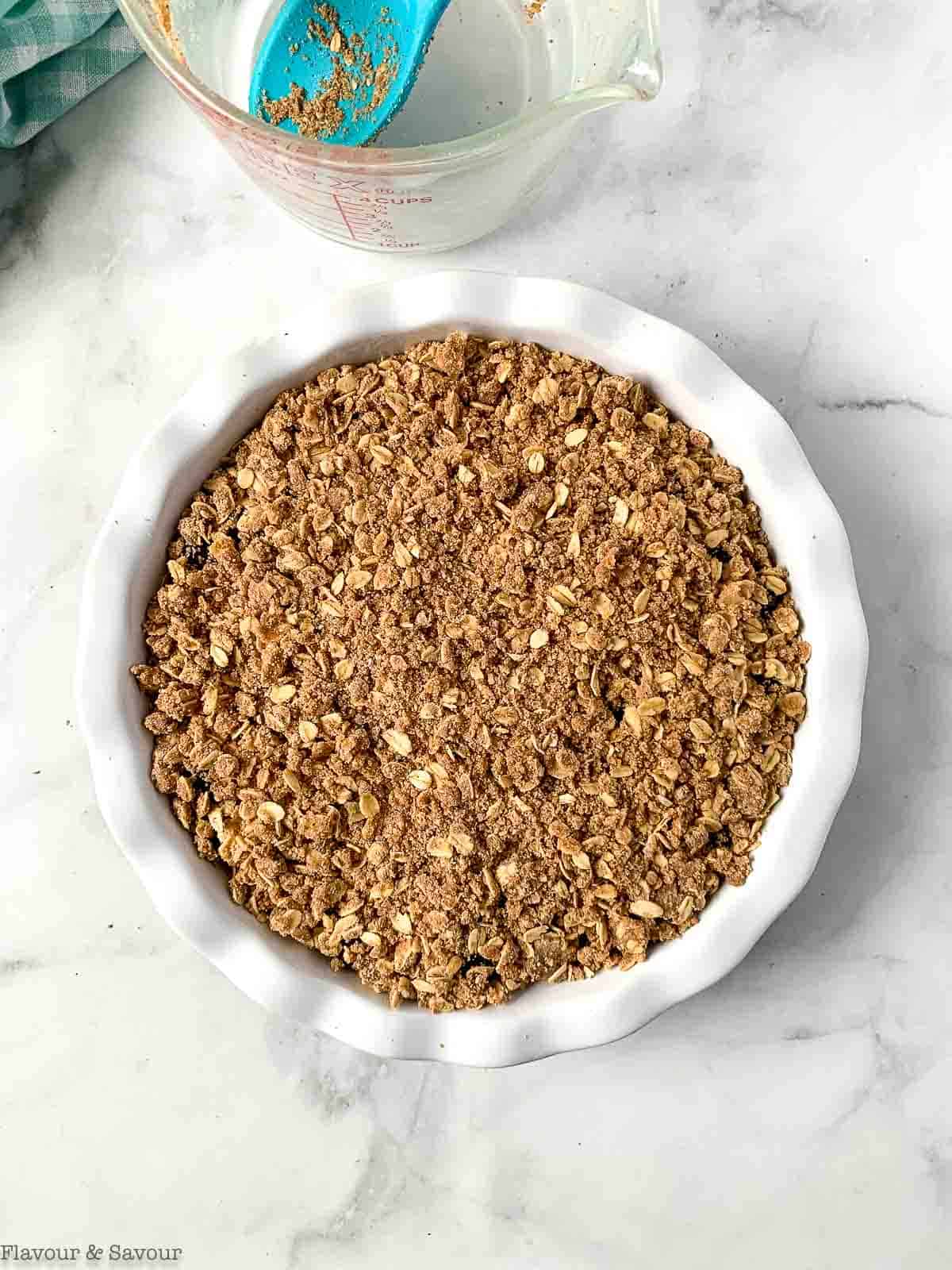 Baked cherry crisp in a round baking dish.