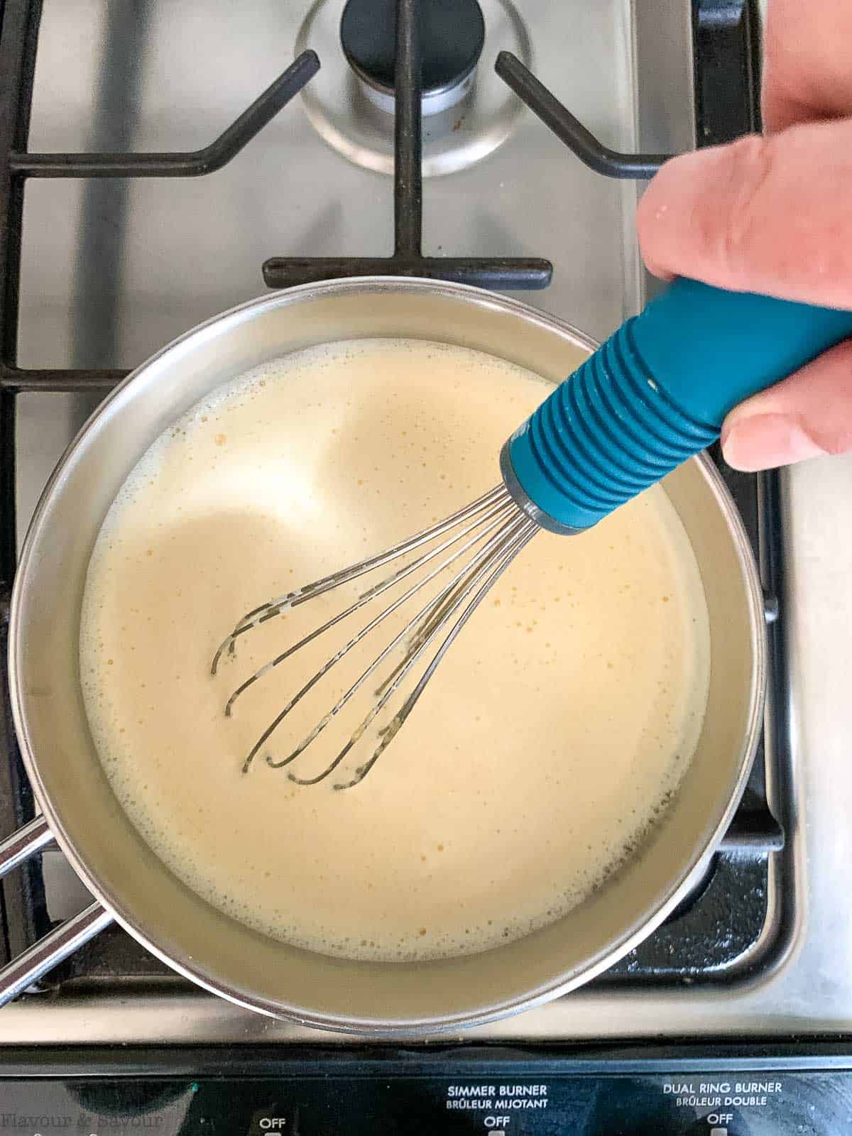 heating milk and vanilla in a saucepan.