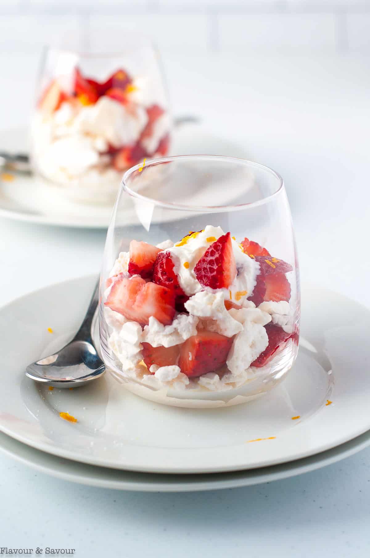 two dessert glasses with traditional strawberry Eton Mess