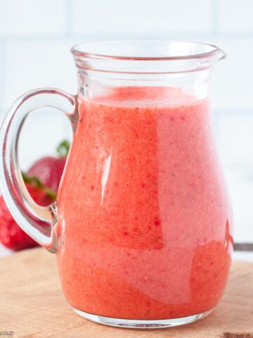 a small jug of strawberry vinaigrette