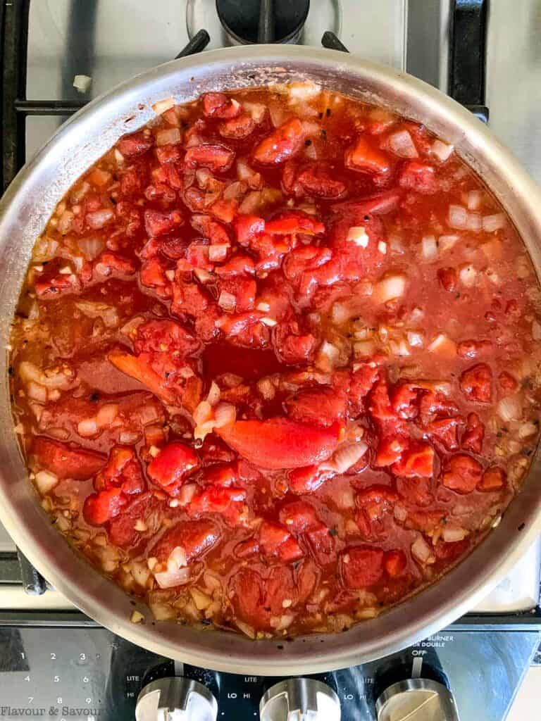 add canned tomatoes to a skillet.