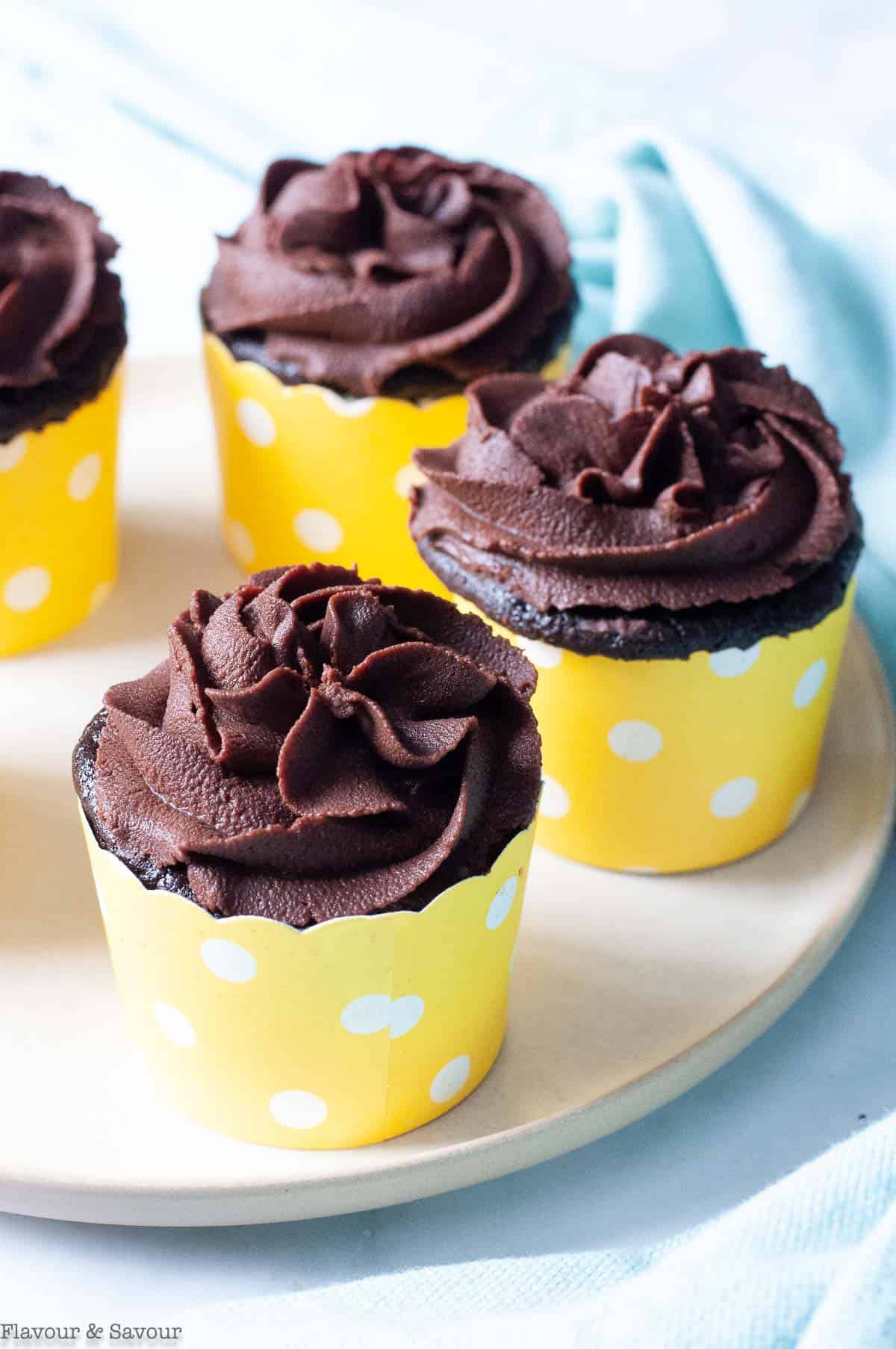 3 quinoa chocolate quinoa cupcakes in yellow cupcake cases.