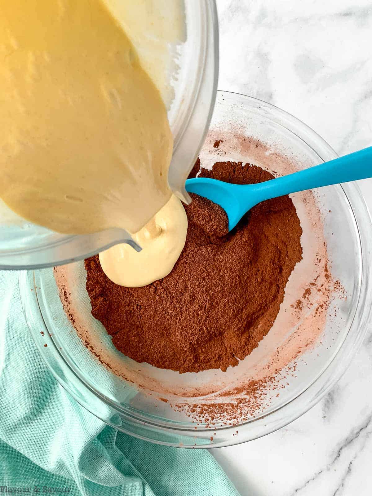 pouring wet ingredients into dry ingredients in a bowl