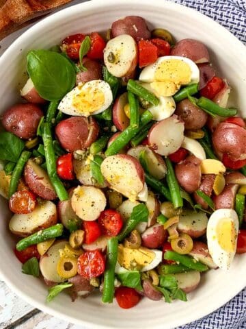 overhead view of a bowl of green bean potato salad with anchovy dressing.