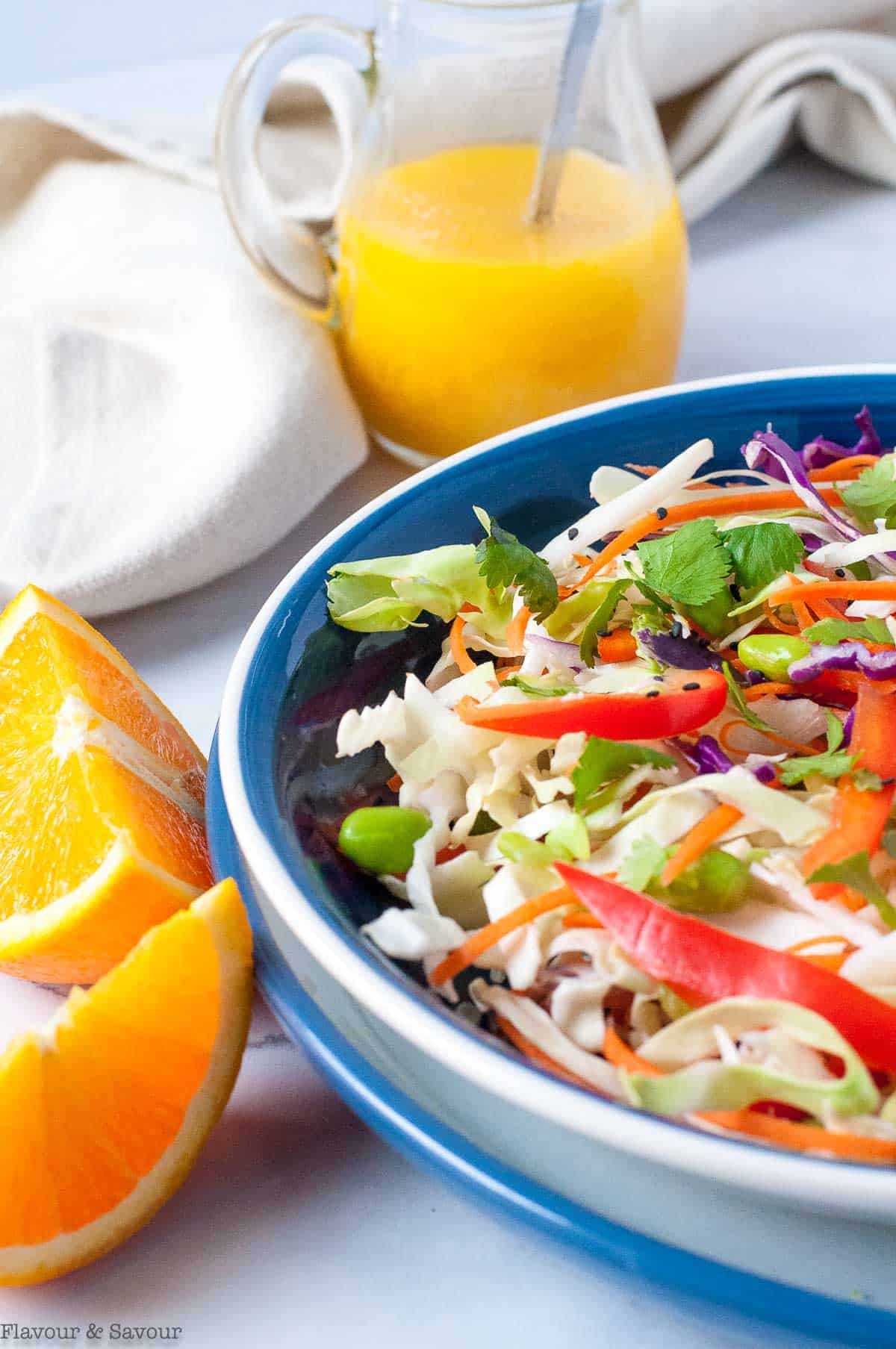 Ginger Orange Dressing beside a bowl of Asian coleslaw.