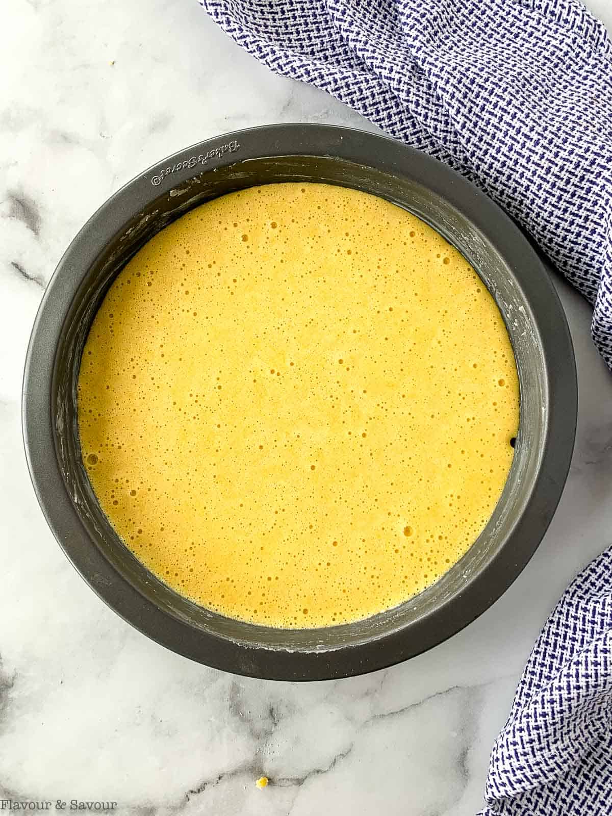 Lemon almond cake batter in a round baking pan.