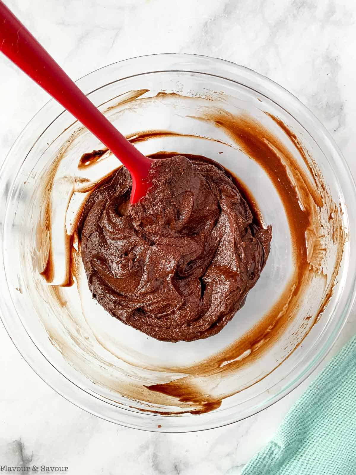 stirring chocolate coconut milk frosting