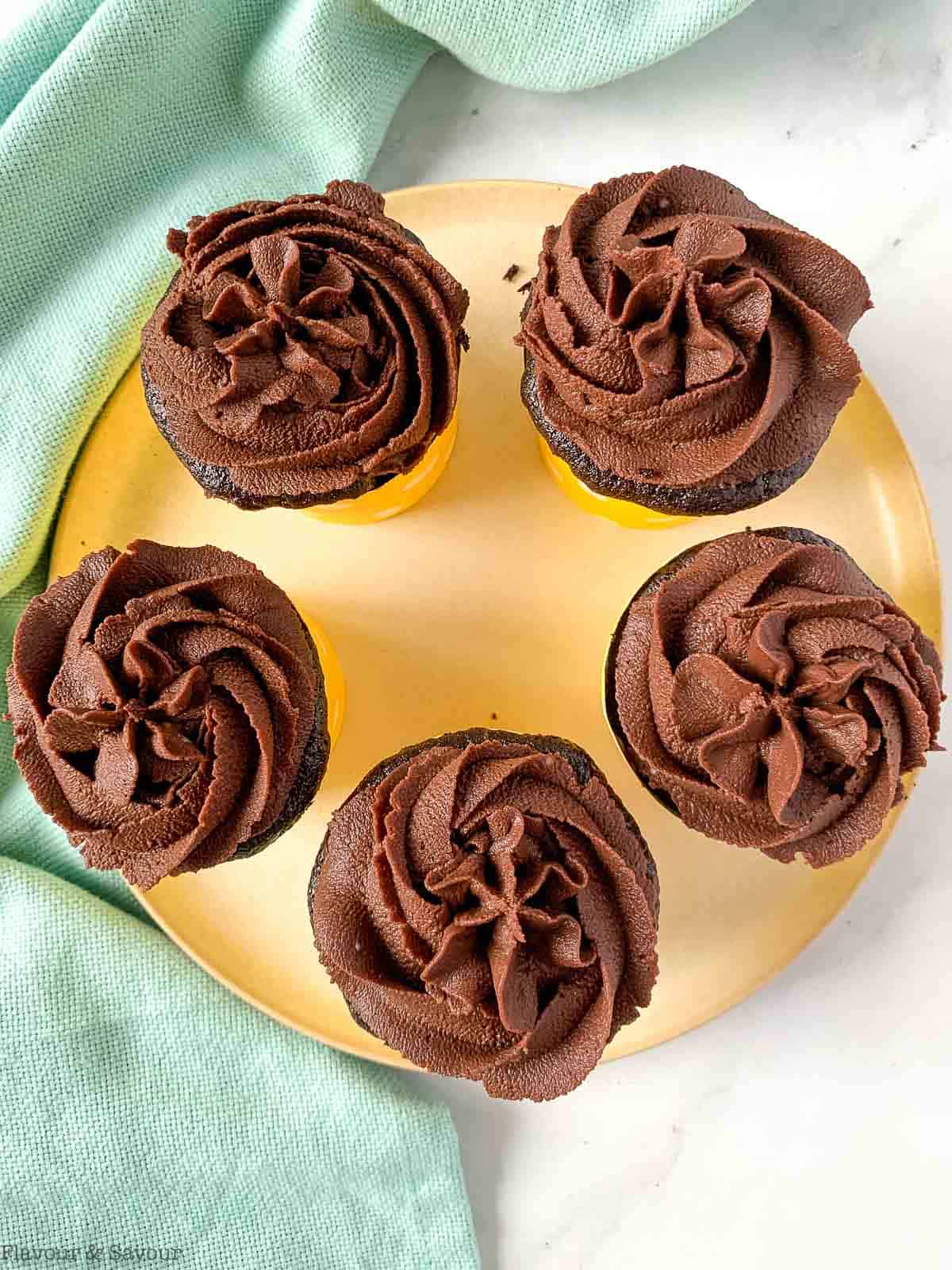 overhead view of 5 quinoa chocolate cupcakes on a plate.