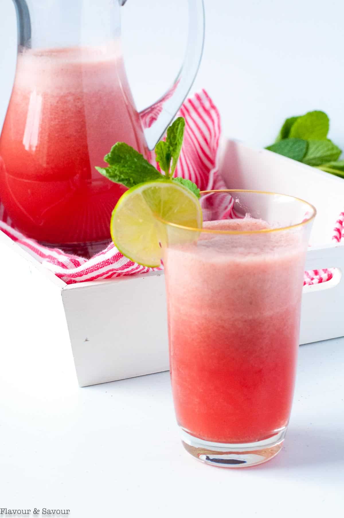 sparkling strawberry limeade in a pitcher and a glass.